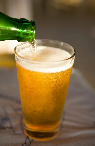 stock image Pouring beer into glass