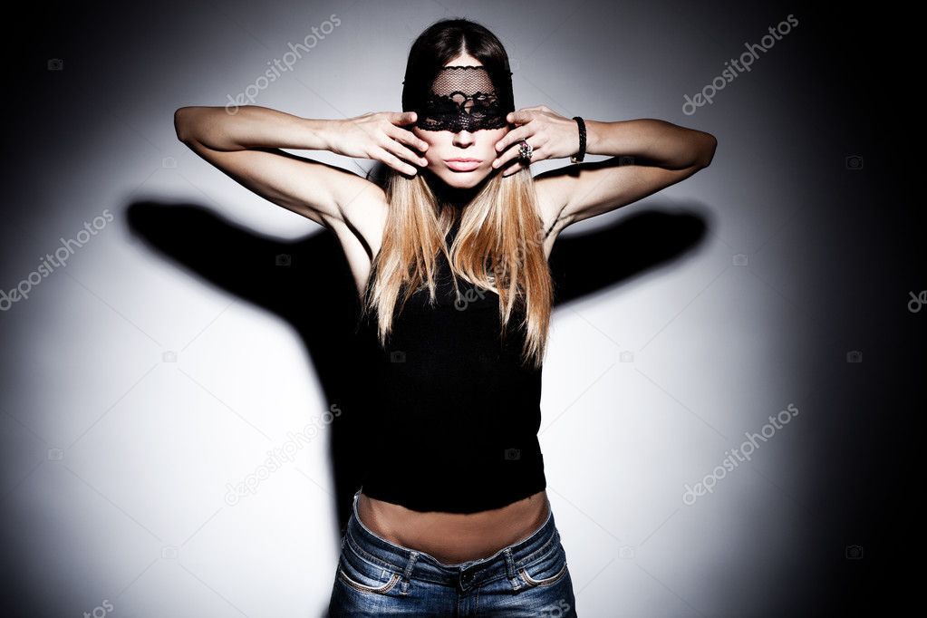 Blond woman with black lace over eyes portrait, hands on face, studio shot, horizobtal