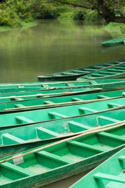 Wooden boats anchored on river (1) clipart