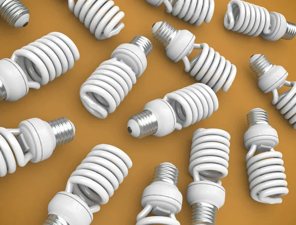 stock image Energy efficient light bulbs on an orange plane. 3D render.