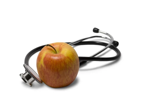 Яблоко со стетоскопом — стоковое фото