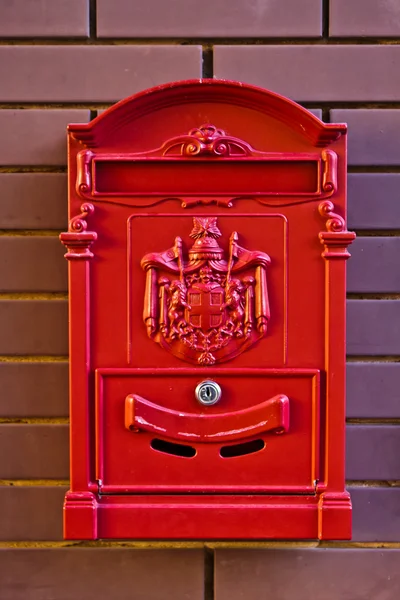 Stock image A red letterbox on the brick wall