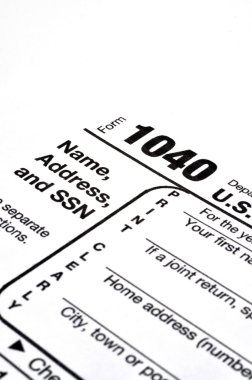 Closeup of IRS form 1040 on white background with ink pen and coffee. clipart