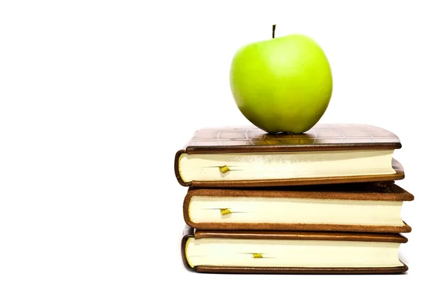 Books and green apple — Stock Photo, Image