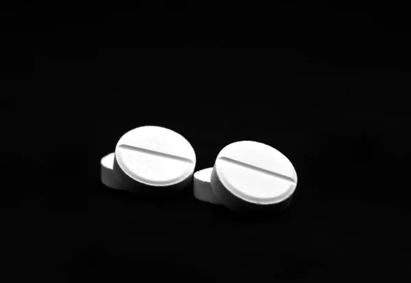 Four white pills — Stock Photo, Image