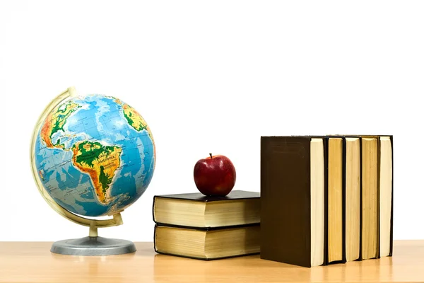Books and apple on a table — Stock Photo, Image