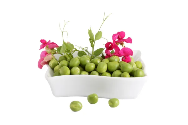 Green Peas and a branch with flowers — Stock Photo, Image