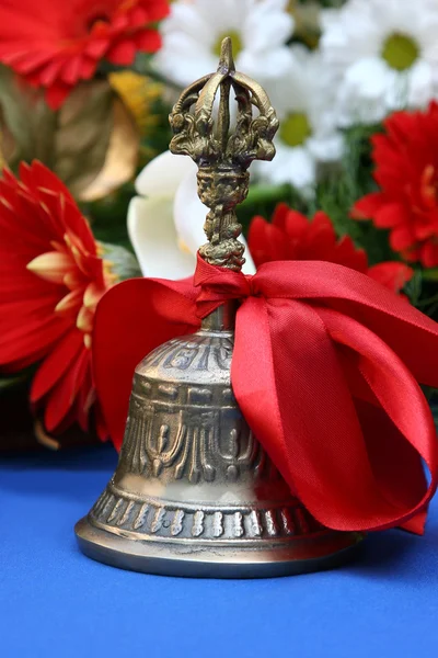 Bronze melodic bell with a red ribbon prom in college — Stock Photo, Image