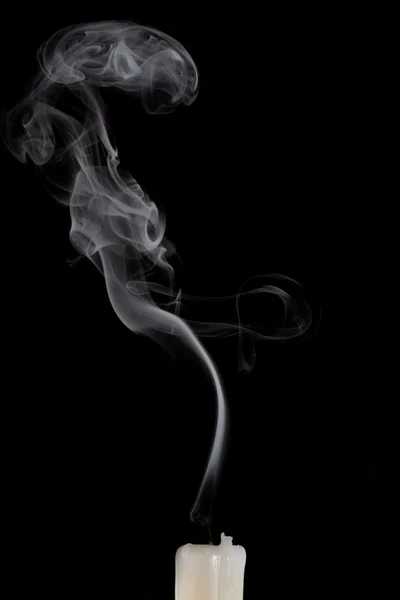 Smoke and extinct candle on a black background — Stock Photo, Image