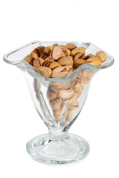 Pistachio nuts and salt in a glass vase isolated on white background — Stock Photo, Image