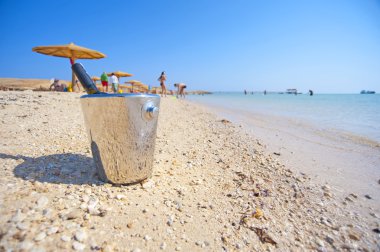 Bottle of wine on a tropical beach clipart