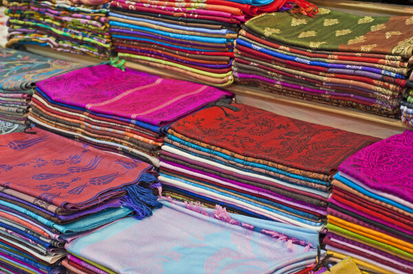 Fabrics and scarves for sale at a market stall