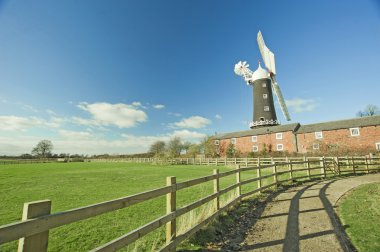 Traditional windmill in the countryside clipart