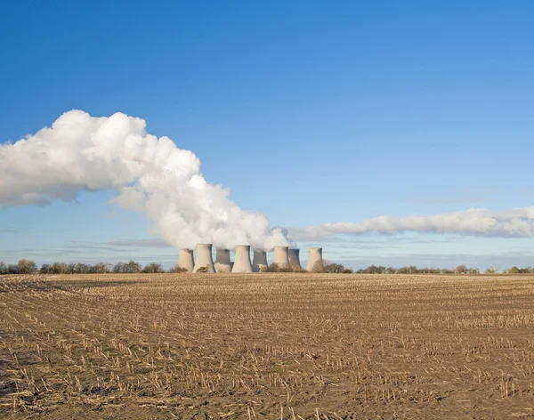 stock image Cooling towers at a power station in the countryside giving off pollution