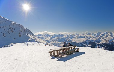 Skiers relaxing on piste clipart