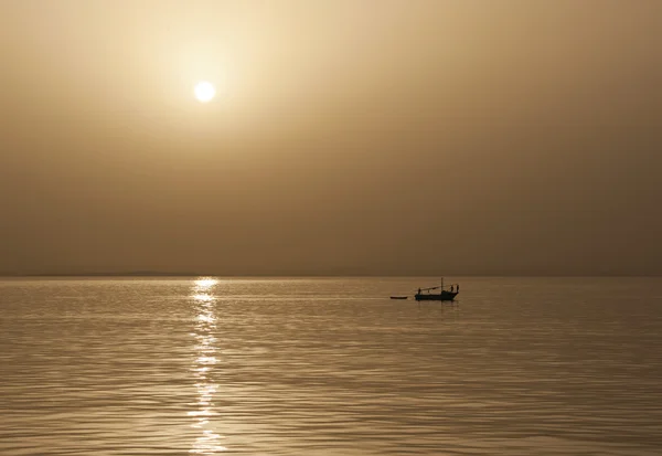 Small fishing boat at sunset — Stock Photo, Image
