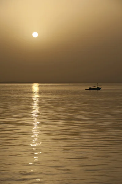 Small fishing boat at sunset — Stock Photo, Image