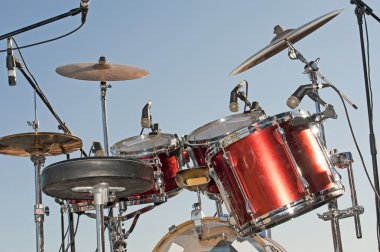 Drumkit against a blue sky background clipart