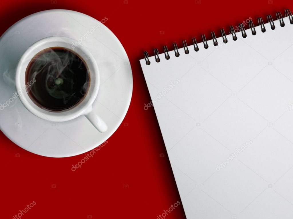 Cup of hot coffe and notebook