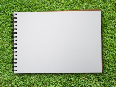 Note book on green grass clipart