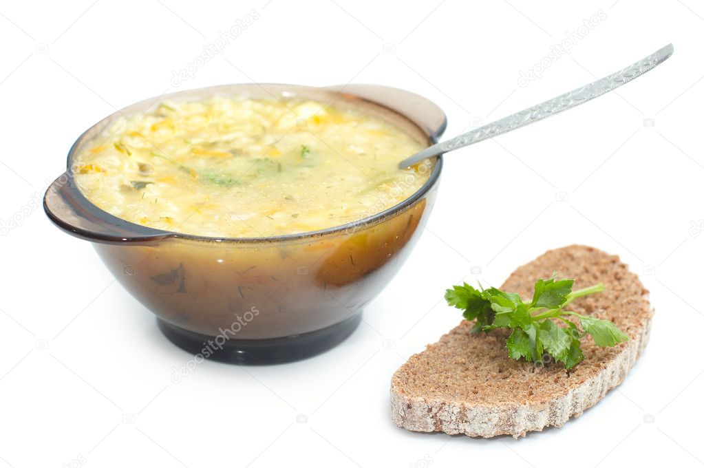 Dish with soup and slice of black bread with parley