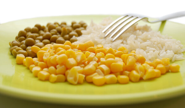 Green plate with rice, peas and sweet corn