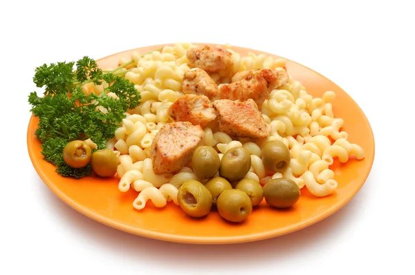 Pieces of fried chicken, pasta and parsley on orange plate — Stock Photo, Image