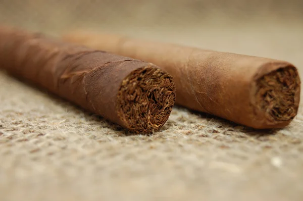 粗麻布画布上的两个古巴雪茄 — 图库照片