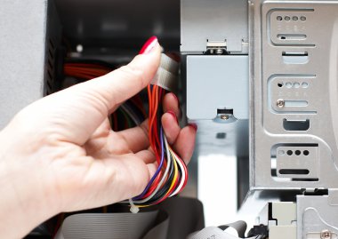 Woman hand assembles computer cable clipart