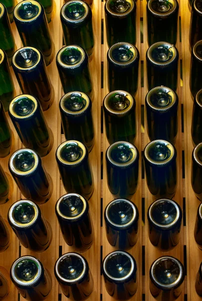 Παλιά ηλικίας κρασί σε μπουκάλια στο ξύλινο βάθρο για οινοποίηση. — Φωτογραφία Αρχείου