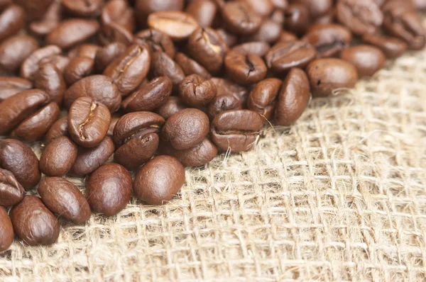 Coffee beans on bagging material — Stock Photo, Image