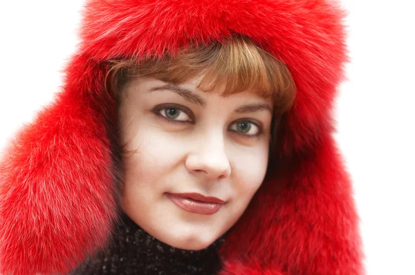 stock image Young attractive woman in red fur-cap