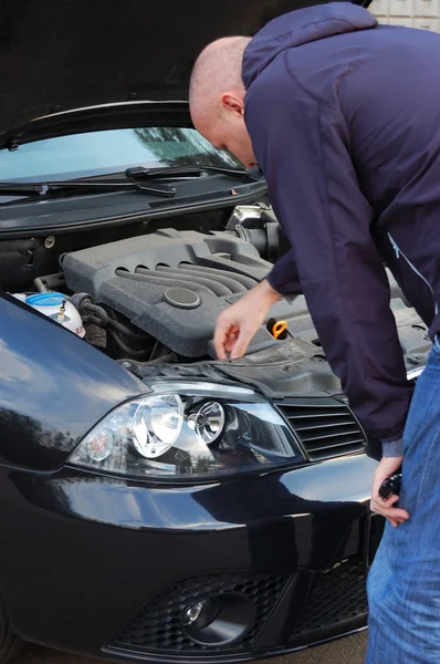 stock image Road breakdown. Man attempts to repair own automobile