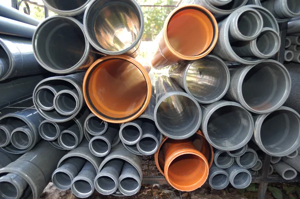 Grey and orange plastic pipes — Stock Photo, Image