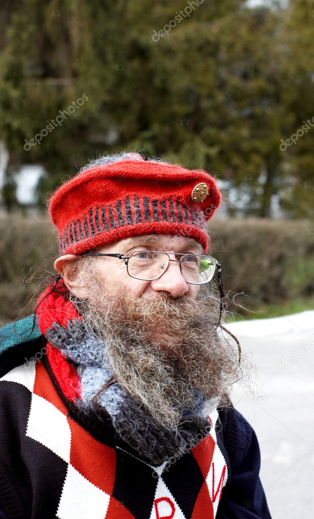Homeless senior in funny red cap