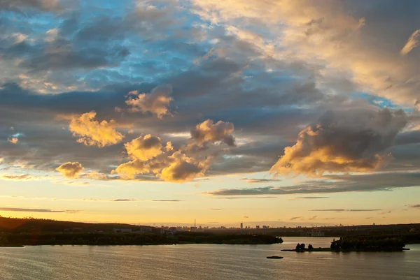 stock image Colorful illuminated the clouds above the city pond