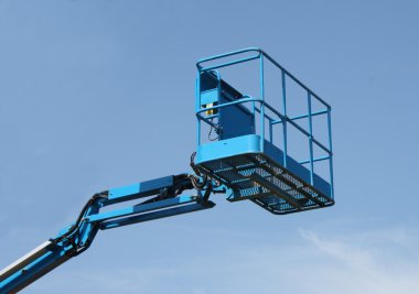 The Top of a Blue Mechanical Lift Vehicle - Cherry Picker. clipart