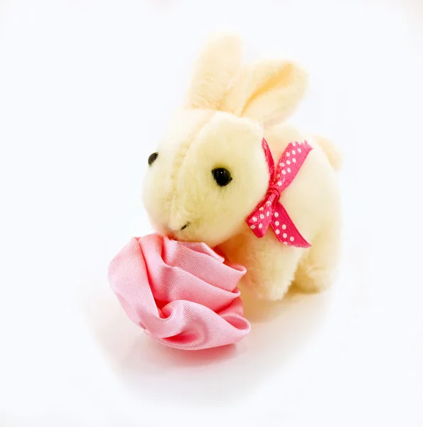 Toy rabbit with rose isolated on white