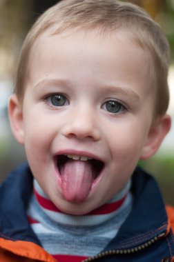 A boy with tongue out