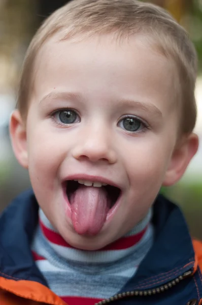 A boy with tongue out — Stock Photo, Image