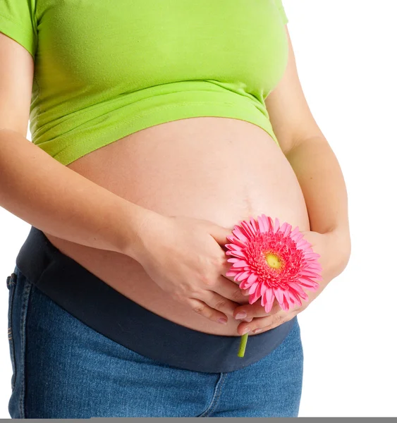 Беременная женщина с цветком — стоковое фото