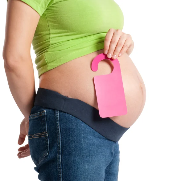 Schwangerschaftsbauch mit Türschild — Stockfoto