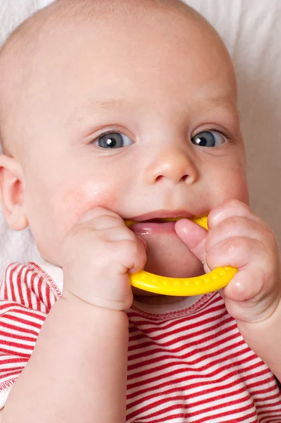 stock image Cute baby with a teething ring