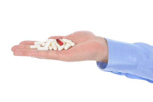 Czerwone i białe tabletki w męskiej dłoni — Zdjęcie stockowe