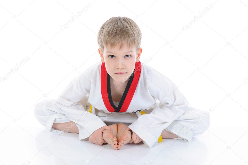 Boy in a kimono sits on a floor