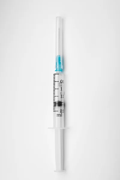 Syringe on gray surface — Stock Photo, Image