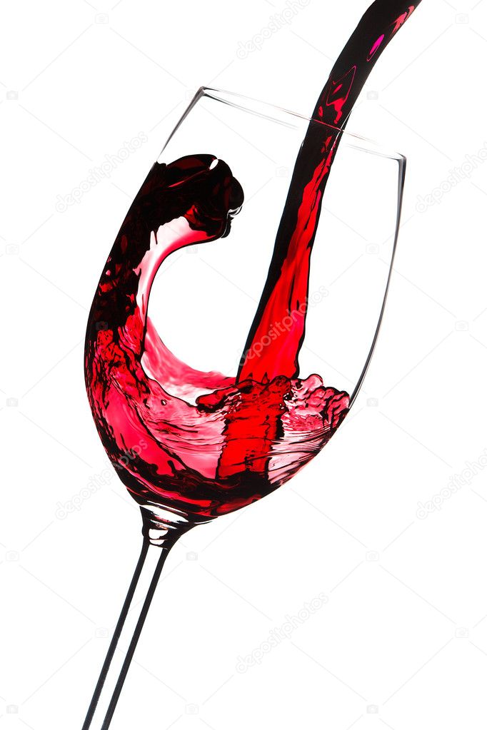 Red wine is poured into a glass. Closeup. Isolated on white back