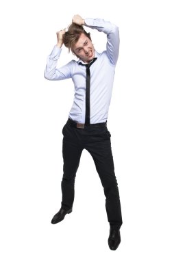 Young man so angry that he wants to pull his hair out. Studio photo, isolated on white. clipart