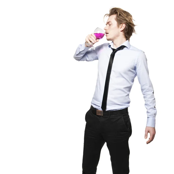 stock image Young man holding a glass of pink wine. Studio photo of blonde man on white background.