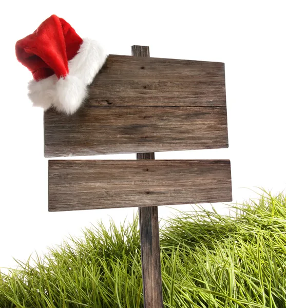 Placa de madeira desgastada com chapéu de Papai Noel em branco — Fotografia de Stock